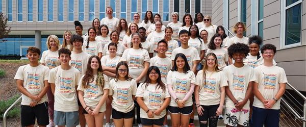 Group of 40 teenage campers wearing matching t-shirts.