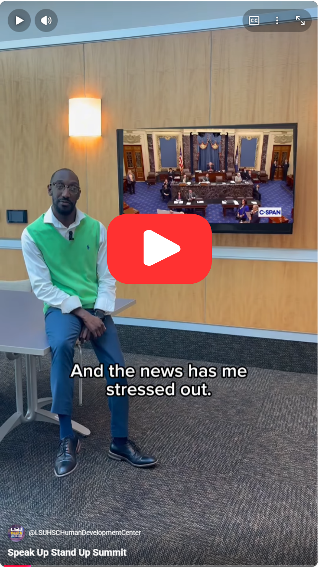 Will sitting on the corner of a table while a tv behind him shows legislators on Capitol Hill. The Caption reads "The news has me stressed out."