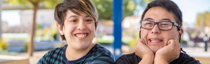 Confused-looking man on right next to woman on left, sitting on a park bench