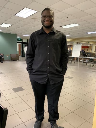 PAYcheck participant Rashad Brooks smiling in a professional outfit. 