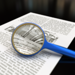 Magnifying glass with focus on paper