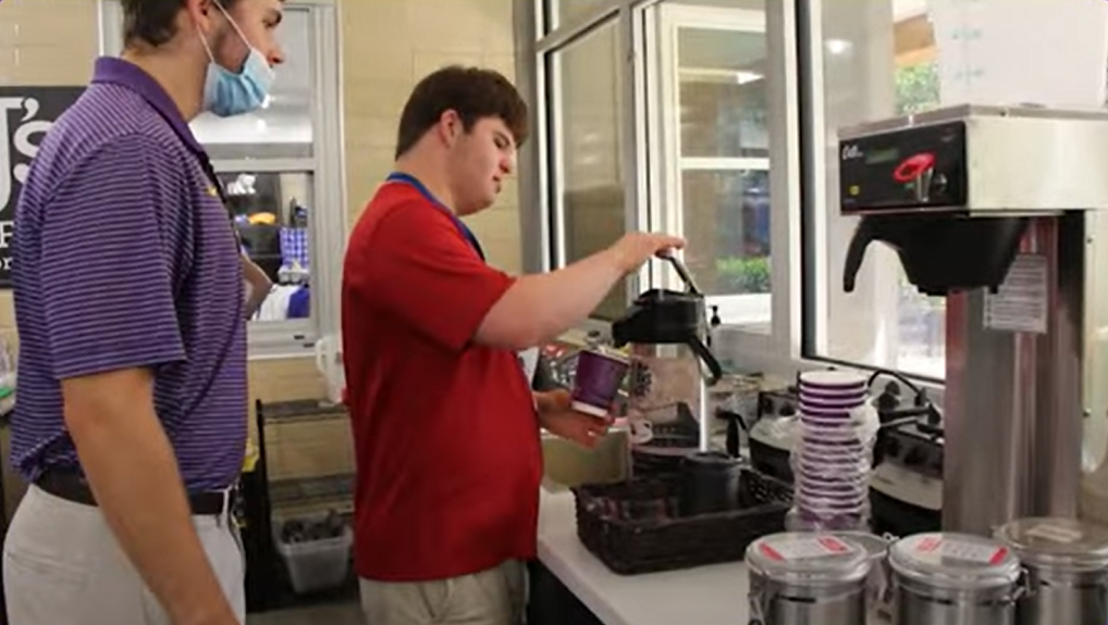 Michael assists PAY Check participant as he makes coffee.