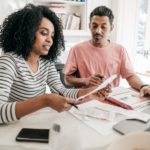 Black woman helping a black man with financial planning